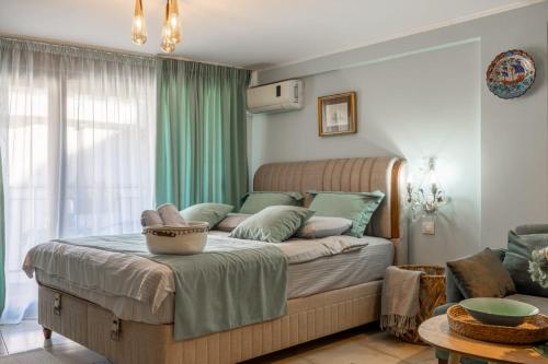 a bedroom with a large bed with green curtains at Centre Budva Blue in Budva