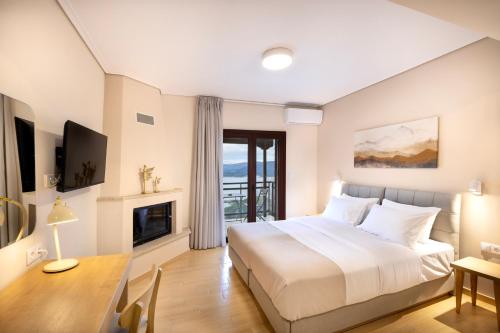 a hotel room with a bed and a fireplace at Lake Kremasta Hotel in Neokhórion