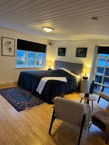 a bedroom with a bed and a chair in it at Kilimanjaro & Stayover in Svinninge