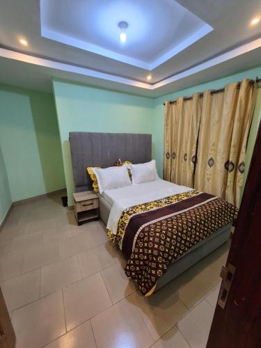 a bedroom with a bed in a room at G and E Guesthouse in Kumba