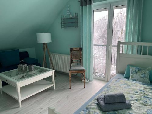 a bedroom with a bed and a desk and a chair at Ferienhaus Rennsteiggruss in Lauscha