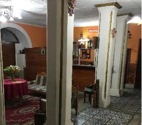 a view of a living room with a table in a room at Hostal La Chorrera in Quito
