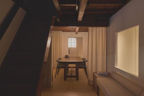a dining room with a table and a couch at new tradition hotel kanazawa in Kanazawa