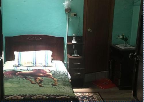 a bedroom with a bed with a horse on it at Hostal La Chorrera in Quito