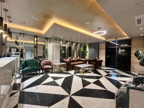 a lobby with couches and chairs in a building at Taj Signature Hotel - F7 Markaz Islamabad in Islamabad