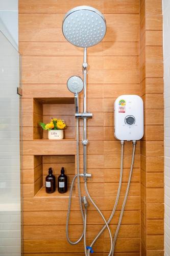 a shower in a bathroom with a shower head at You Baan Pool Villa Cha-am in Ban Bo Prakhon