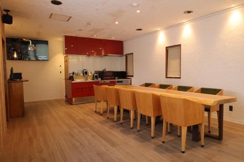 a kitchen with a long wooden table and chairs at Kamakura in Iiyama