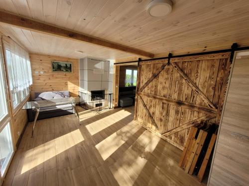 a sliding barn door in a room with a bed at Domek nad Gopłem in Połajewek
