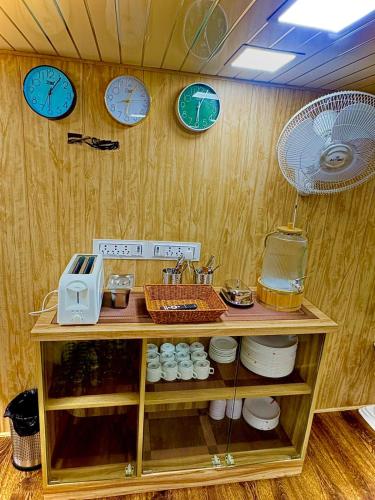 a room with clocks on the wall and a shelf at Cannaught Stays in New Delhi