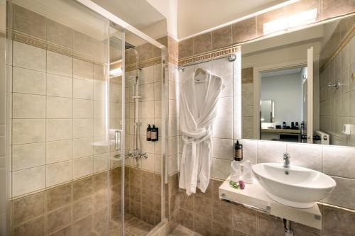 a bathroom with a sink and a shower at Lake Kremasta Hotel in Neokhórion