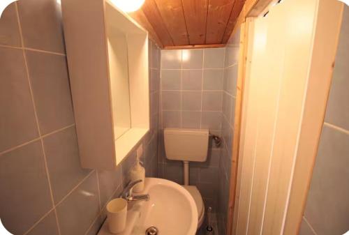a small bathroom with a toilet and a sink at Tiny Nest Over Naples, Private Panoramic Terrace in Naples