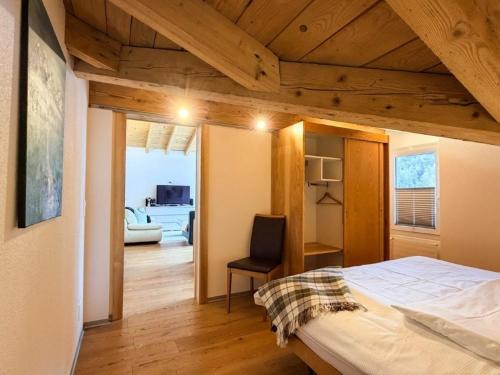 a bedroom with a bed and a living room at Saaserhof Apartments in Saas-Fee