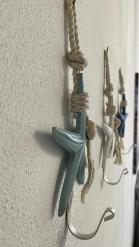 a blue hook hanging on a wall with rope at Frida Apartment in Chioggia