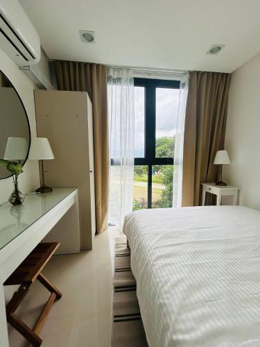 a bedroom with a bed and a large window at Unit 509 - One Pontefino Tower in Batangas City