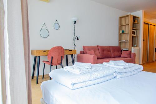 a room with a bed and a table and a couch at Студио 8 Уютна Почивка in Hisarya
