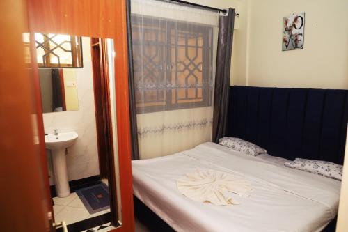 a small bedroom with a bed and a sink at PALISADES homes in Voi