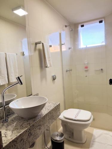 a bathroom with a sink and a toilet and a shower at Arca's Hotel Umuarama in Umuarama