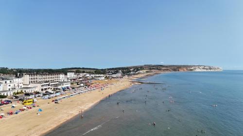 a group of people on a beach near the water at Bay View - Seafront, Sandown, Isle of Wight in Sandown