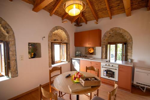a kitchen with a wooden table and a dining room at Armonia Sun Tower in Exochori