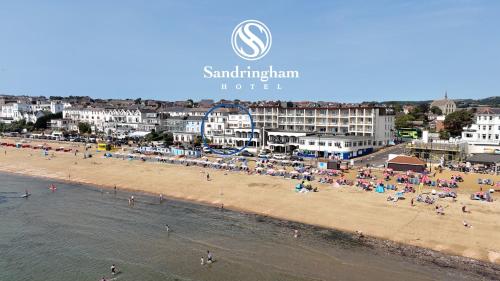 a group of people on a beach near the water at Regent Court - Seafront, Sandown, Isle of Wight in Sandown