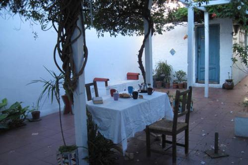 a table with a white table cloth and two chairs at Stone Wasi in Montevideo