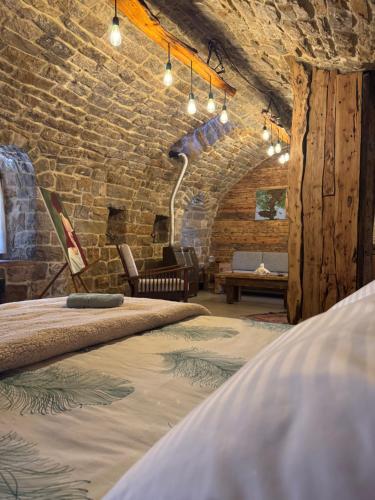 a room with a bed and a brick wall at Bayt Wadad, Bcharre Lebanon in Bcharré