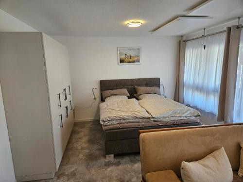 a bedroom with a bed in a room with a window at Torwirt Apartments in Herrieden