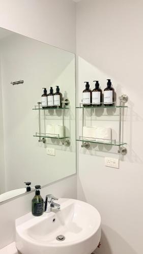 a bathroom with a sink and a mirror at One Bedroom with Balcony in Abreeza Mall in Davao City