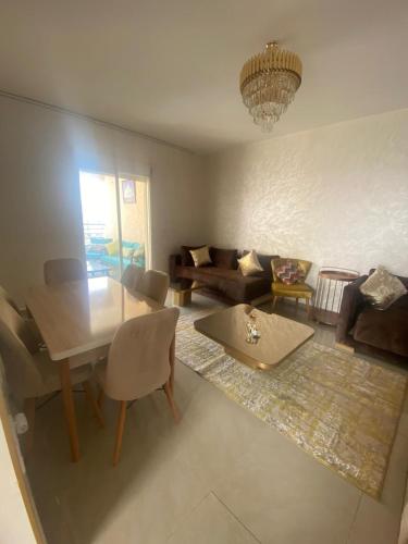 a living room with a table and a couch at Super Logement in Tangier