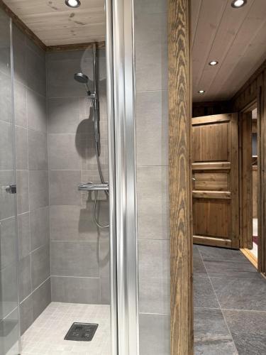 a shower with a glass door in a bathroom at Large cottage with beautiful view in Trysil in Trysil