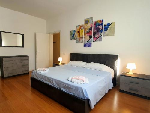 a bedroom with a large bed with two night stands and two lamps at Casa di Giada - Venice Gateway - Family Comfort - Free Public Parking& Tram -Link in Mestre
