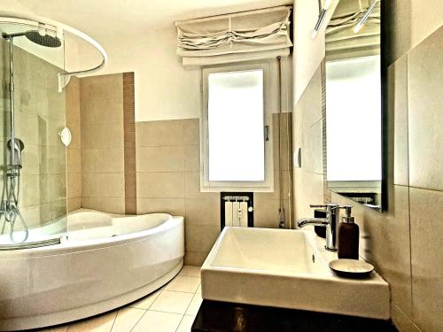 a white bathroom with a tub and a sink at Casa di Giada - Venice Gateway - Family Comfort - Free Public Parking& Tram -Link in Mestre