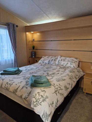 a bedroom with a bed with two towels on it at Ocean Front Lodge in Hartlepool