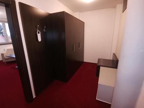 a door with a purse hanging on it in a room at Hotel Monde in Uherský Brod