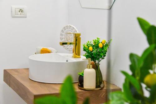 a bathroom with a sink and flowers on a table at Vila Manuela Techirghiol in Techirghiol