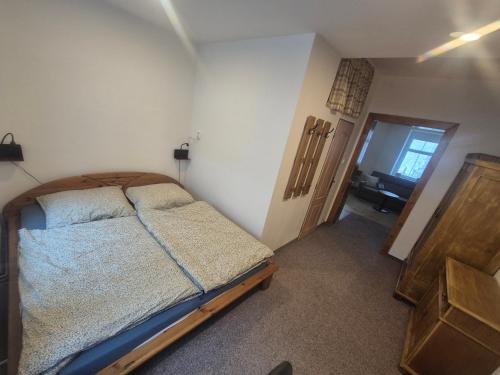 a bedroom with a bed in a room with a door at Apartmán U Vaňků in Jáchymov