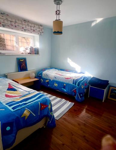 a bedroom with two beds and a window at Villa Büyükada I Private Pier & Seawater Pool in Istanbul