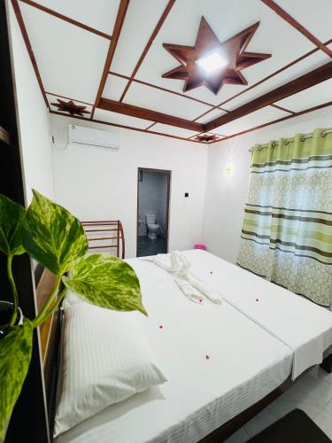 a bedroom with a bed with a star on the ceiling at Sigiriya Hidden Home Stay in Sigiriya