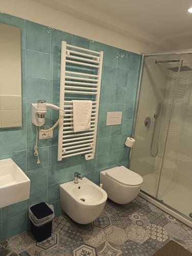 a bathroom with a sink and a toilet and a shower at Locanda B&B Dandana in Orgosolo