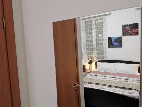 a bedroom with a bed and a window at Dimora Venice Station in Mestre