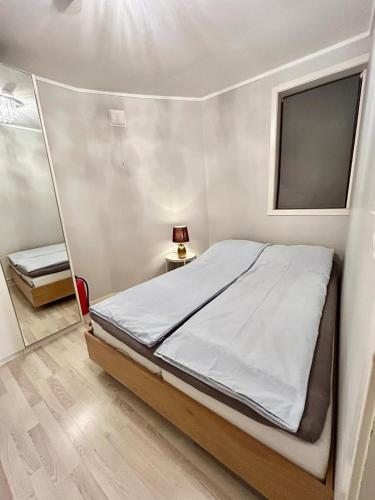a bedroom with a bed and a mirror at Cozy Apartment in Central Alesund Close to Everything in Ålesund