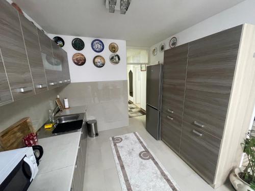 a kitchen with a sink and some plates on the wall at Apartman Deluxe in Novi Travnik
