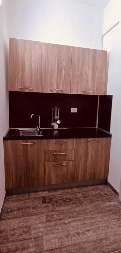 a bathroom with a sink and wooden cabinets at Art home Amalfi coast in Salerno