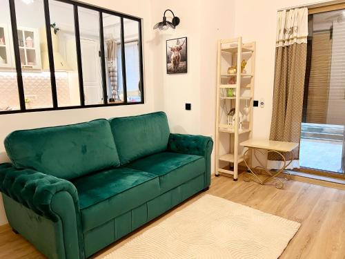 a green couch sitting in a living room at Summer Studio in Constanţa