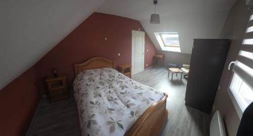 a bedroom with a bed with a white comforter at Chambre proche circuit 24h du mans in Spay