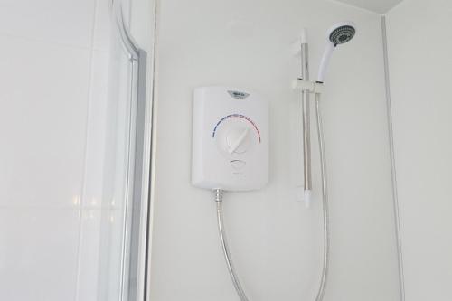 a shower with a shower head in a bathroom at Annie's Accommodation in South Shields