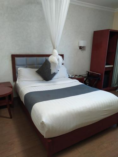 Vuode tai vuoteita majoituspaikassa Olive Hotel