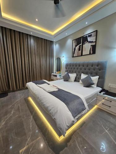 a large bedroom with a large bed with a lighted bed frame at Hotel Crystal Sarovar in Mirzāpur