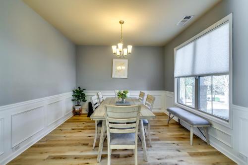 a dining room with a table and chairs and a window at Open Plan Arcade Home with Natural Hardwoods Sleeps 10 in Atlanta