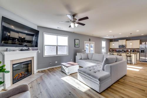 a living room with a couch and a fireplace at Open Plan Arcade Home with Natural Hardwoods Sleeps 10 in Atlanta